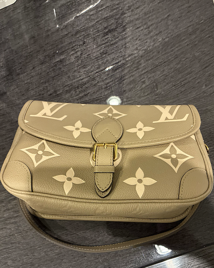 2023 Louis Vuitton Accessories Diane MM Monogram Empreinte Giant 10IN x 6IN x 3.5IN Tourterelle Creme Leather Gold-Toned Hardware Leather Strap 9.25IN x 19.75IN Drop (Diane MM)