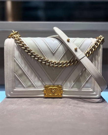 Chanel Boy Flap Bag Chevron Caviar Medium White Leather 11IN x 7IN x 3IN Gold-Tone Hardware Chain/Leather Strap (Chevron)
